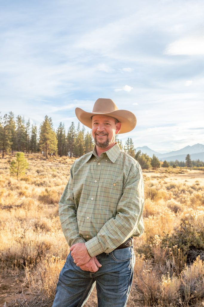 Mac Even outdoors wearing a cowboy hat